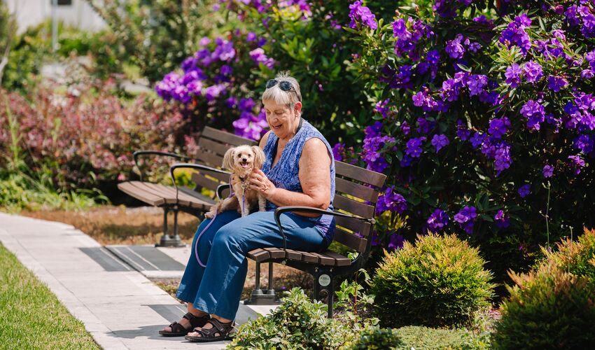 Lady and dog sitting on bench